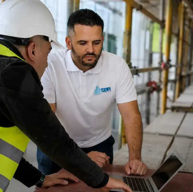 SBR Construction crew reviewing plans on a Tampa home building site